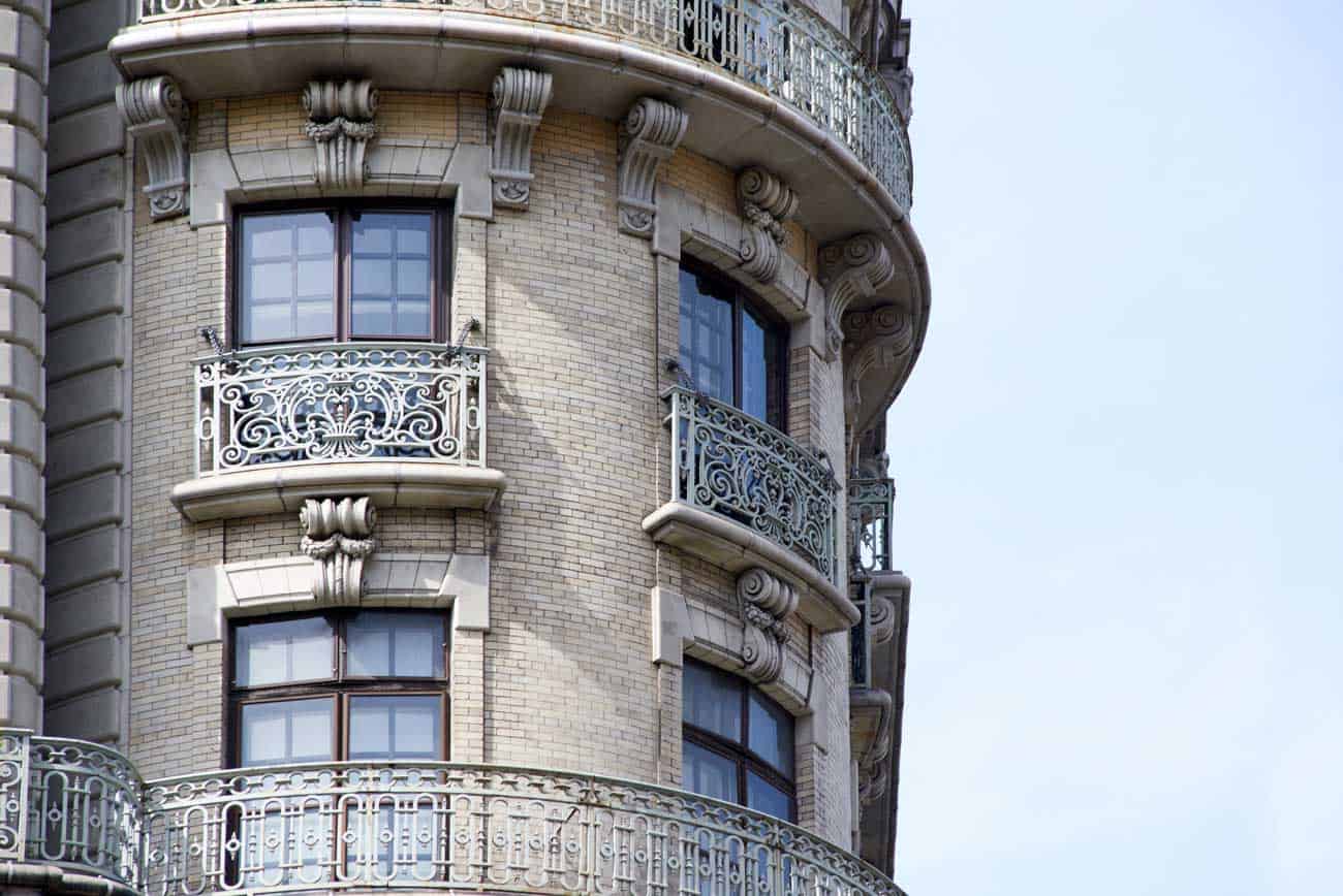 An ornate New York City building with storm window.