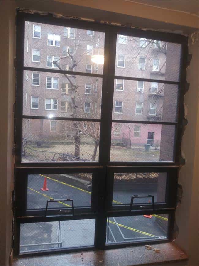 A window in a room that is being remodeled.