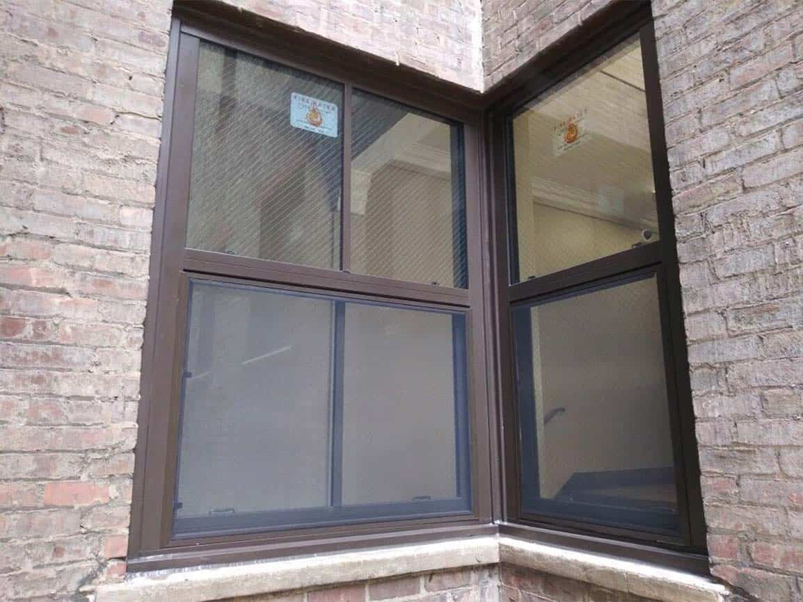 A fire rated window in a brick building.