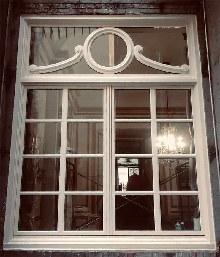 WindowFix supplied and installed these ornate wood windows from Parrett.