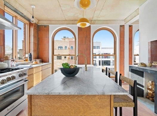 This is an image of large wooden arch top windows in the kitchen of a condominium in Brooklyn, New York City.