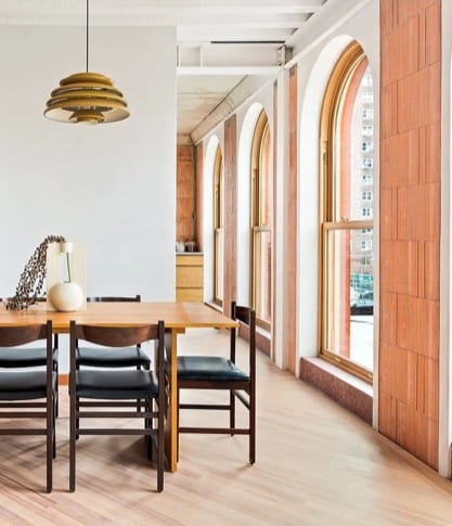 This is an image of large wooden arch top windows in the dining room of a condominium in Brooklyn, New York City.